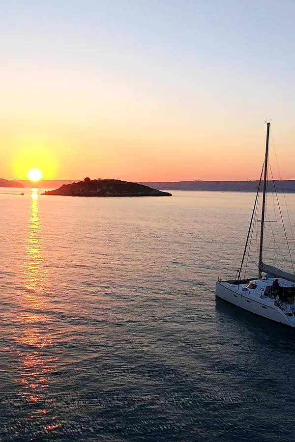 Souda Bay Sunset View Catamaran Infront of Karga Island sunset in souda bay
