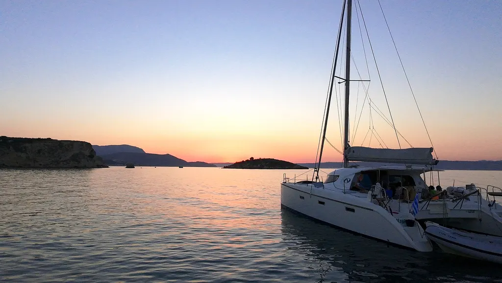 Souda Bay Sunset View Catamaran Infront of Karga Island sunset in Almyrida