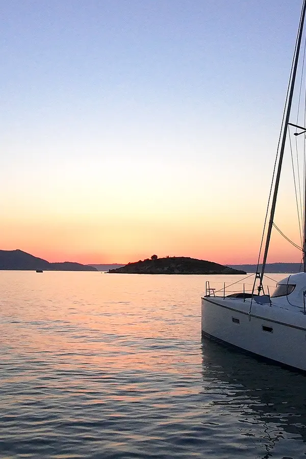 Souda Bay Sunset View Catamaran Infront of Karga Island sunset in Almyrida