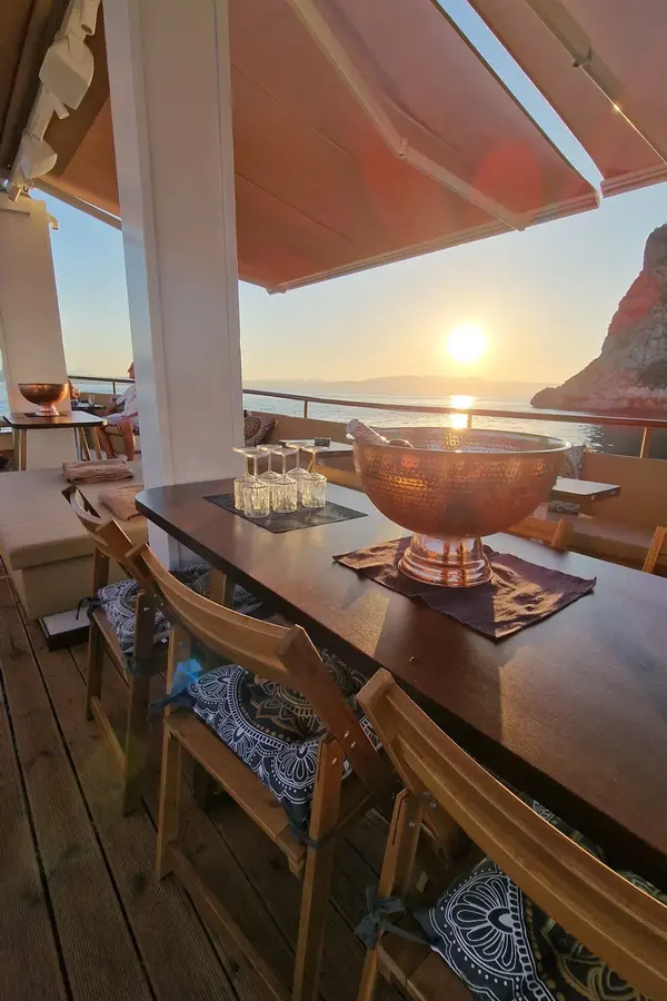 Irini boat deck table sunset view