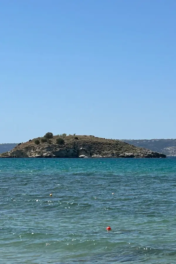 White-washed buildings and the clear blue sea view in Almyrida village, Crete.