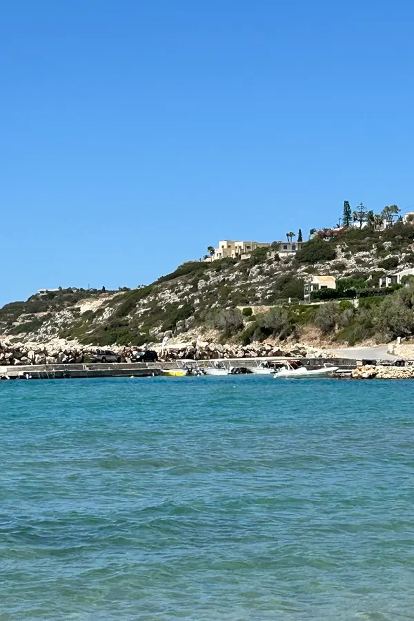 Bright blue Aegean Sea meeting the rocky coastline near Almyrida, Crete.