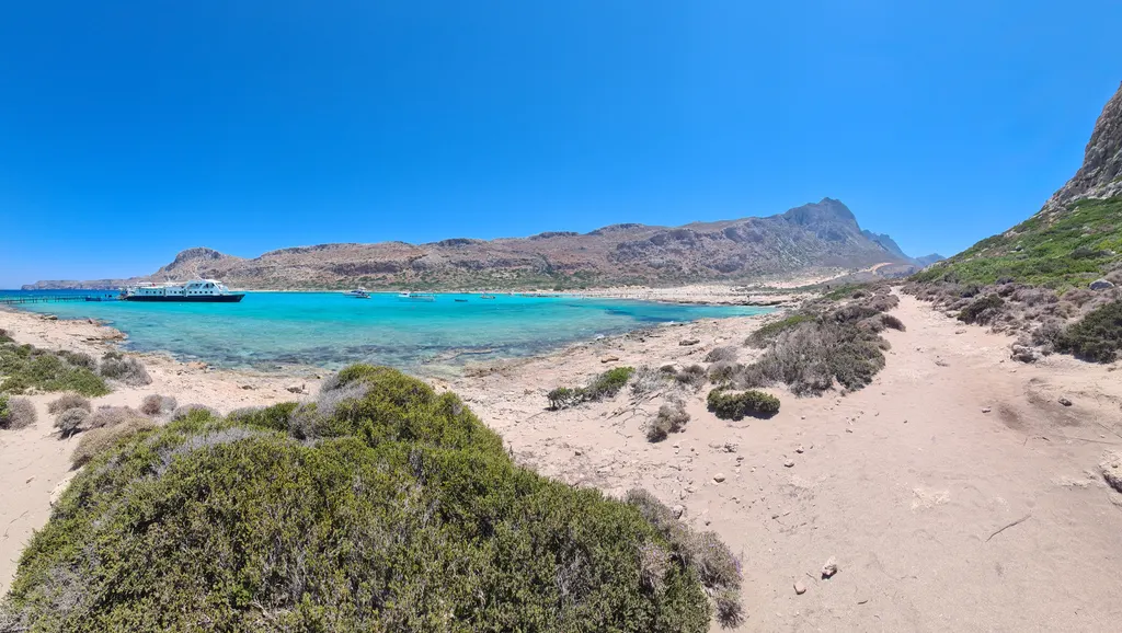 Crystal clear turquoise lagoon and white sandy beach spread out at Balos peninsula, western Crete.