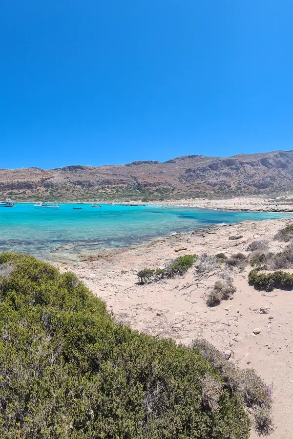 Crystal clear turquoise lagoon and white sandy beach spread out at Balos peninsula, western Crete.