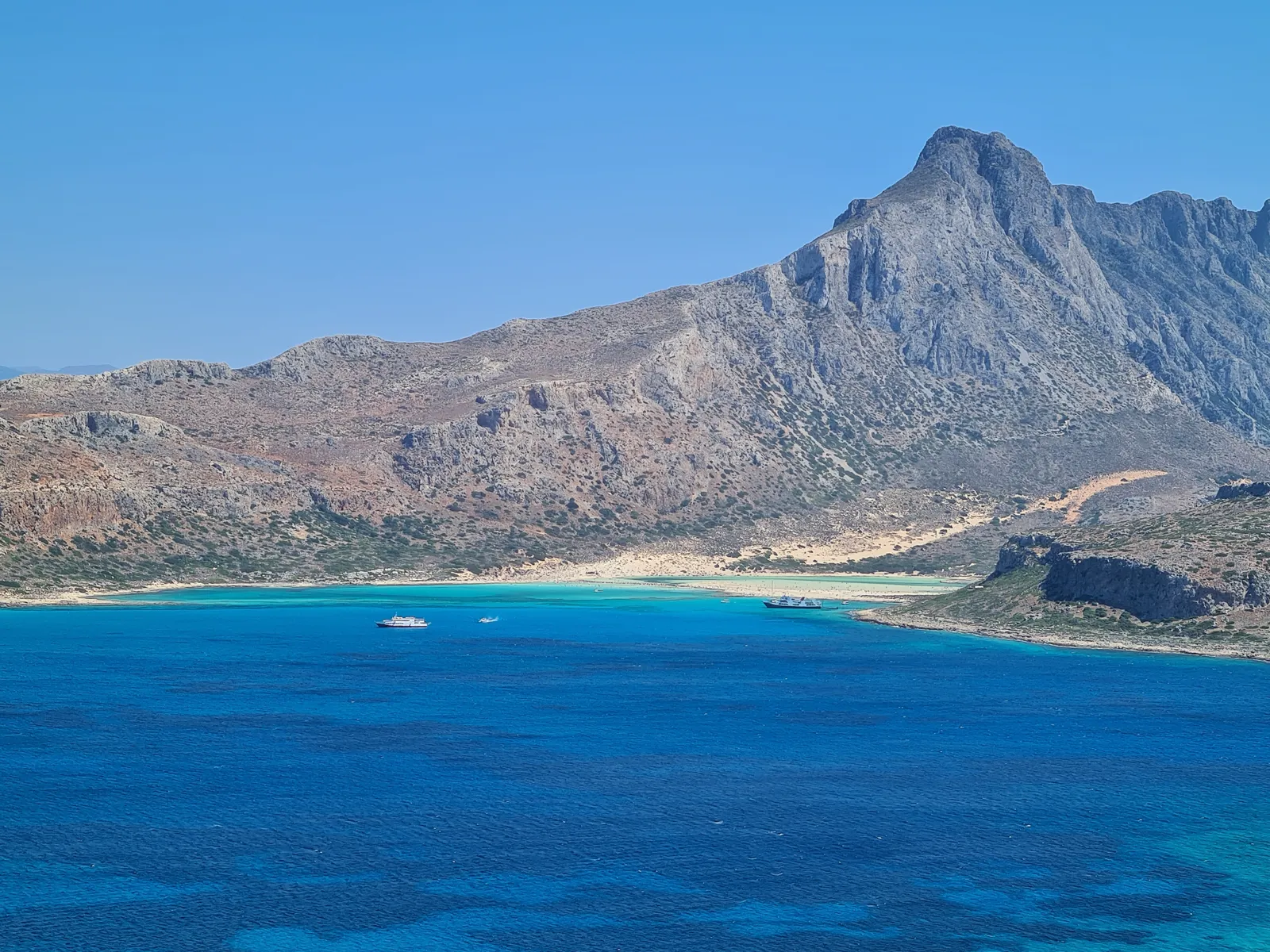 Pristine white sands meeting the brilliant turquoise lagoon at Balos, western Crete.