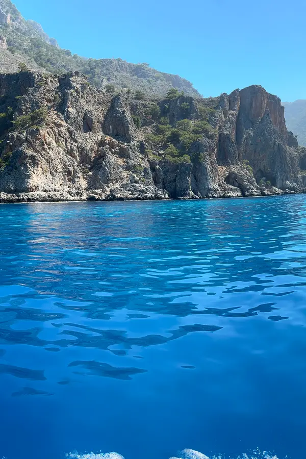 The village of Domata nestled against the dramatic cliffs overlooking the deep blue Cretan Sea.