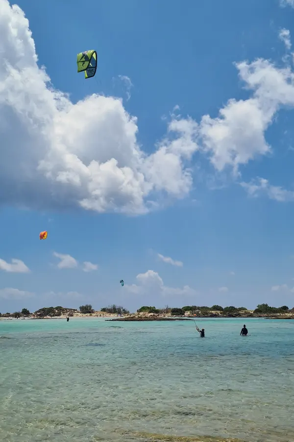 Pale pink sand and shallow lagoon waters characterize the famous Elafonissi beach in Crete.