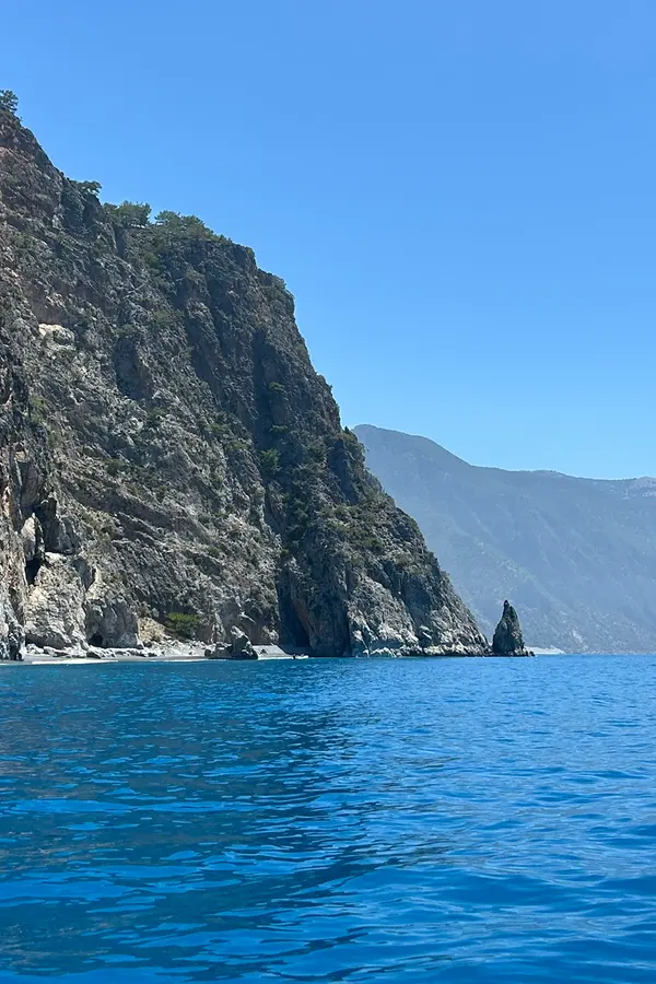 Dramatic limestone cliffs and deep blue waters viewed from Kalogeros on the scenic Cretan coast.
