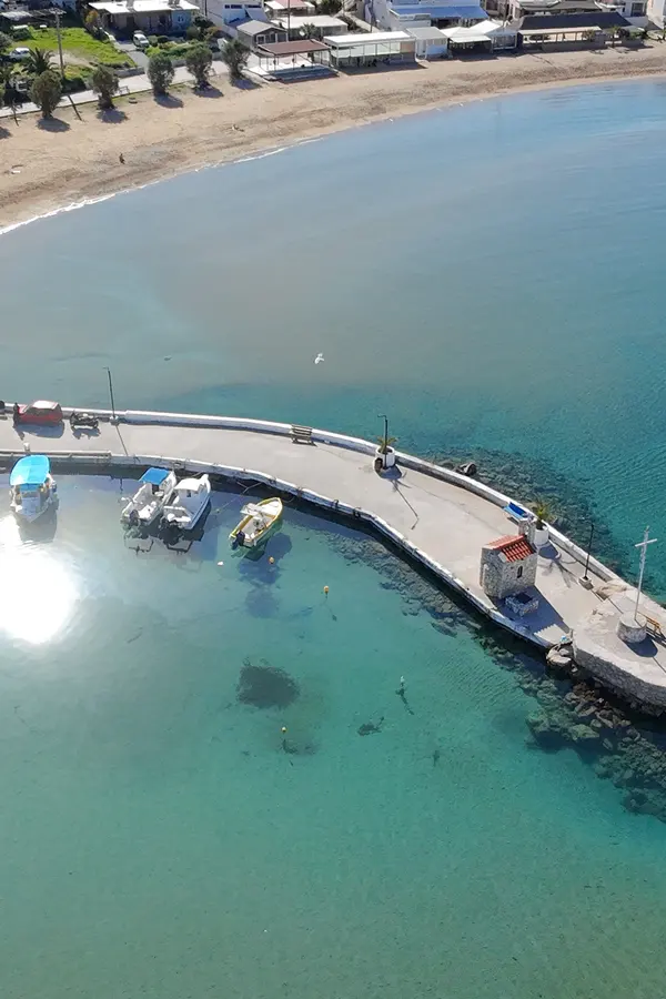 Deep blue waters meeting the shore at Kalyves, offering views of the rugged Cretan coastline.