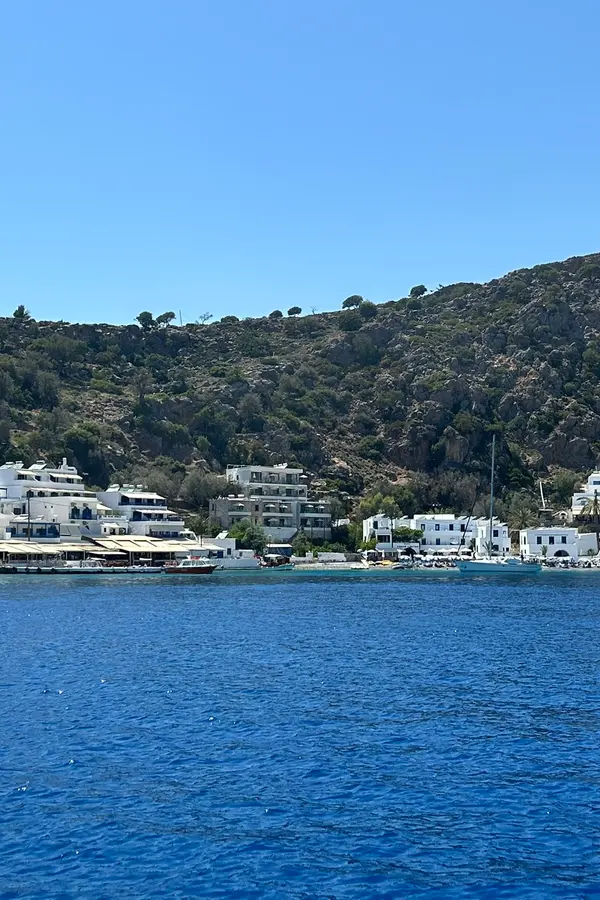 Quaint harbor and traditional white houses of Loutro village, set against the deep blue waters of the southern Cretan coast.
