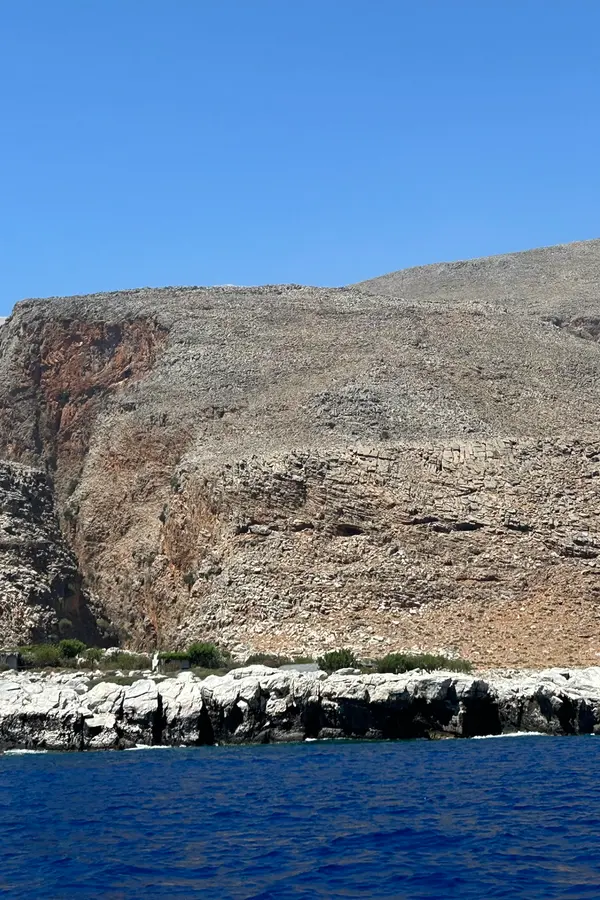 Dramatic limestone cliffs and turquoise waters defining the picturesque coastline of Marmara, Crete
