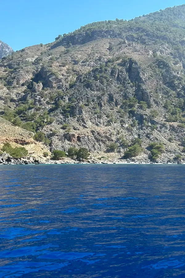The charming coastal village of Sendoni nestled among the green landscape of western Crete, Greece.