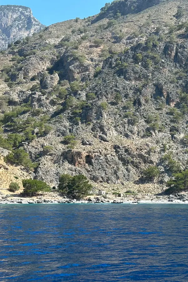 Rugged coastline and clear blue Aegean Sea views overlooking the village of Sendoni in Crete
