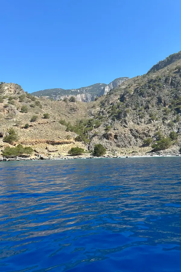 Dramatic rugged coastline and clear blue waters visible at Sendoni cape, Crete.