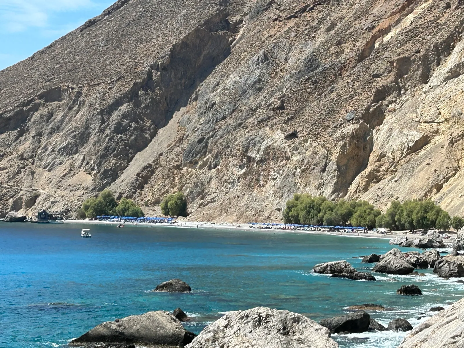 Rugged coastline, steep mountain cliffs, and deep azure waters surrounding Sfakia on the southern coast of Crete.