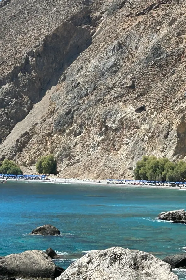Rugged coastline, steep mountain cliffs, and deep azure waters surrounding Sfakia on the southern coast of Crete.