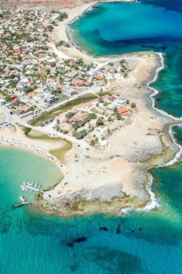 Clear turquoise waters meeting the rugged shoreline near Stavros, a beautiful destination in Crete.