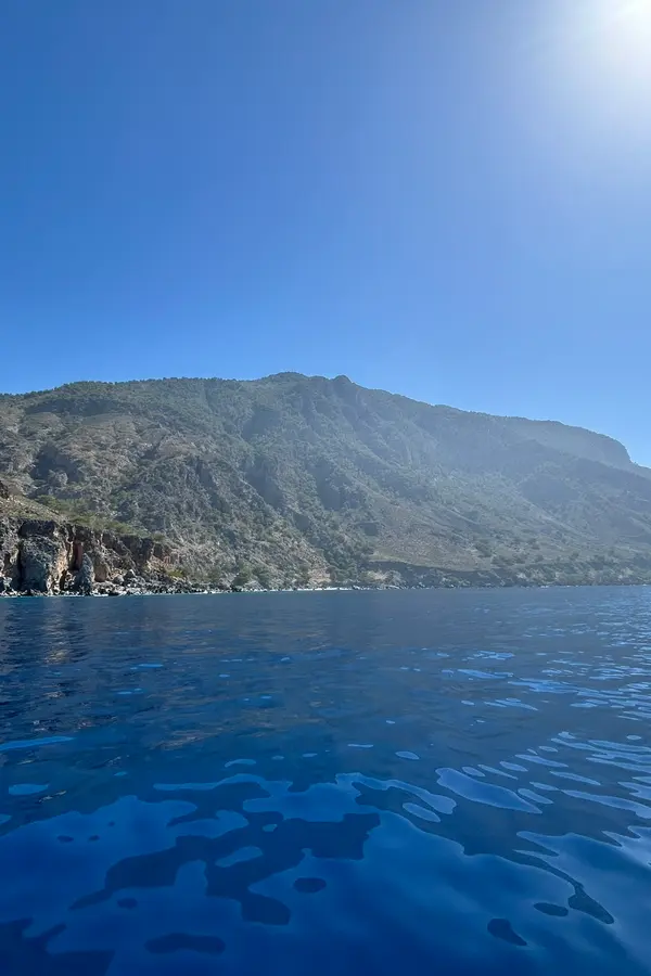 Dramatic cliffs and deep blue waters surrounding Tripiti cape, a secluded spot on the south coast of Crete.