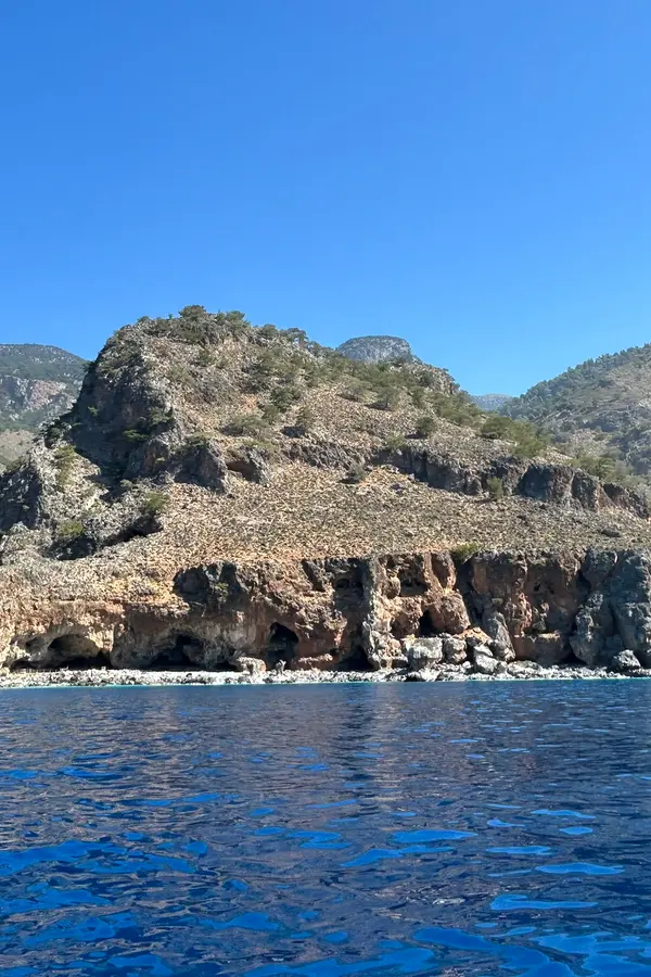 Dramatic rugged shoreline and turquoise waters of the remote Tripiti cape on Crete's southern coast.