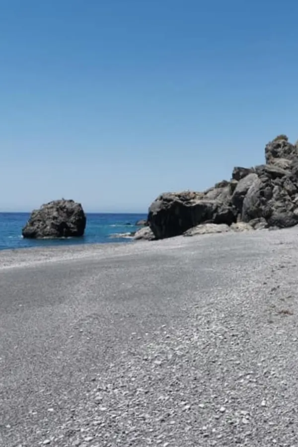 Rugged headland and clear blue waters visible at Fournoti cape, on the southern coast of Crete.