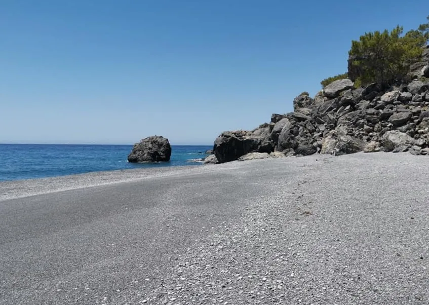 Rugged headland and clear blue waters visible at Fournoti cape, on the southern coast of Crete.