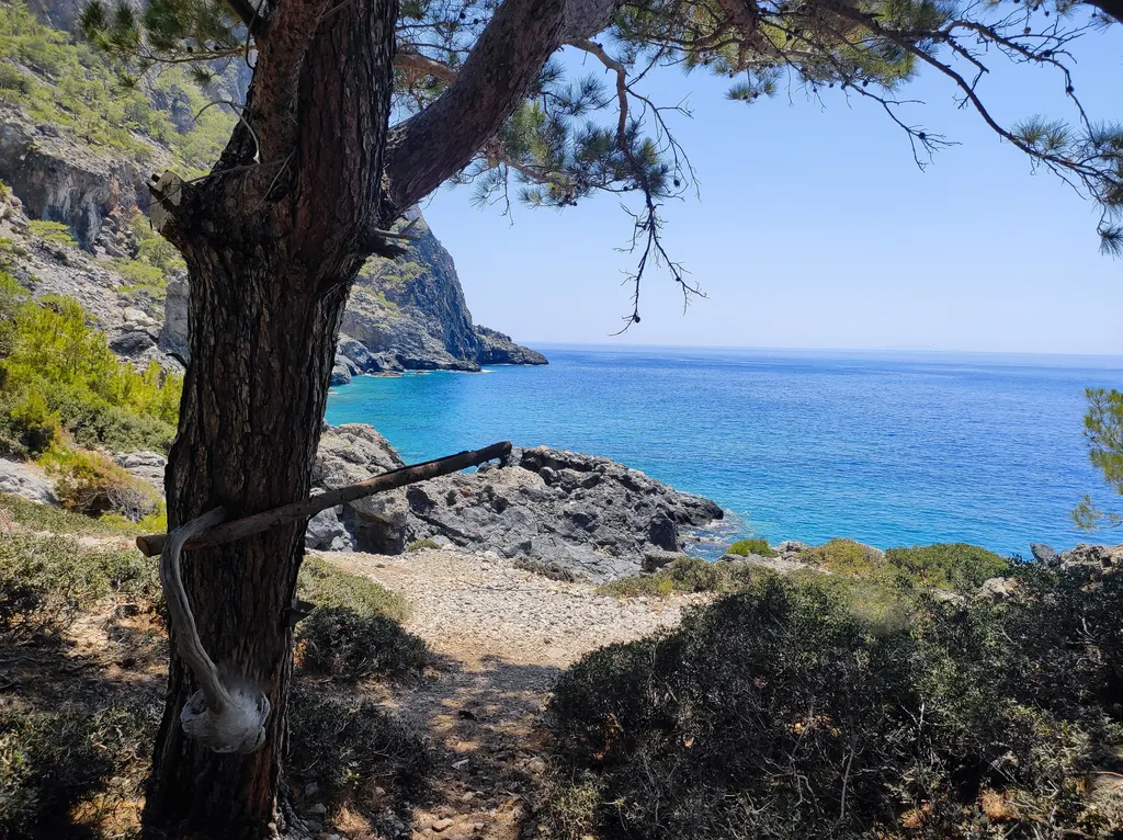 Deep blue Aegean Sea waters and moored boats off the picturesque coast near Bahri, Crete