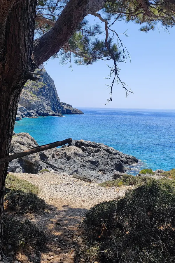 Deep blue Aegean Sea waters and moored boats off the picturesque coast near Bahri, Crete